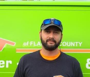 Male Technician in front of SERVPRO vehicle