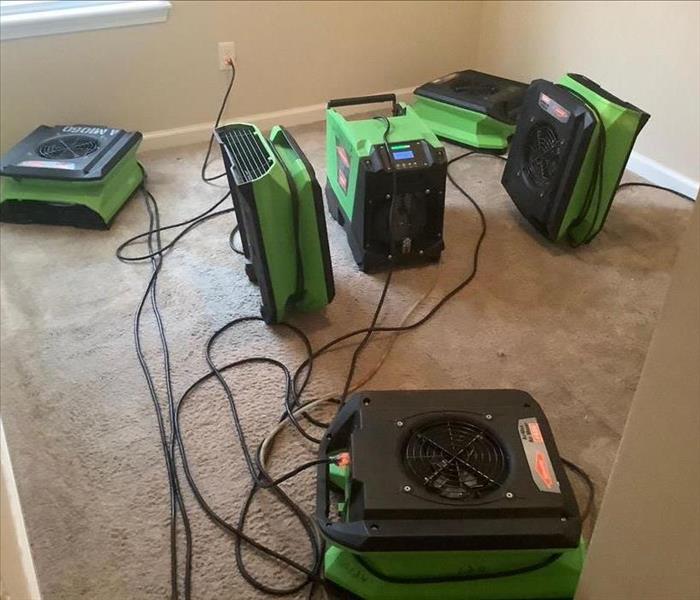 a picture of a bunch of air movers placed in a small room with carpet