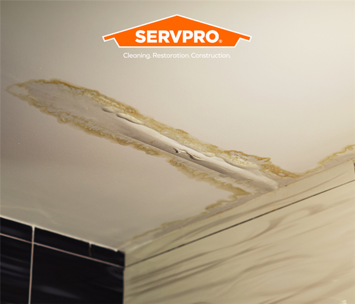 ceiling with water damage and SERVPRO logo
