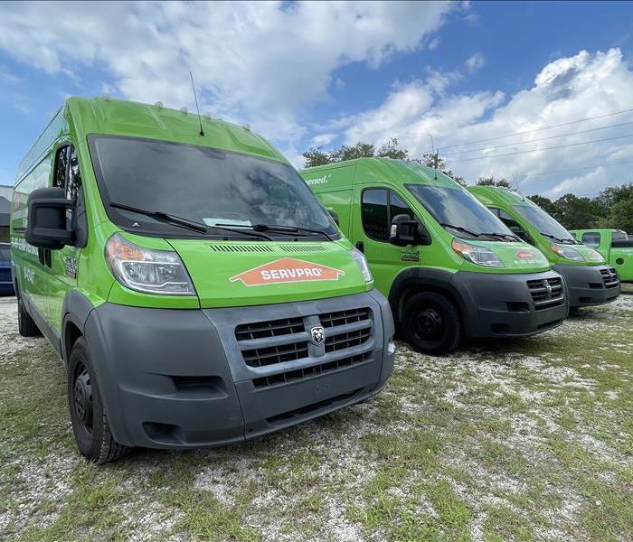 3 SERVPRO trucks lined up in a row in our parking lot.